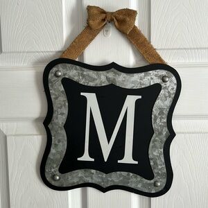 Decorative initial “M” hanging